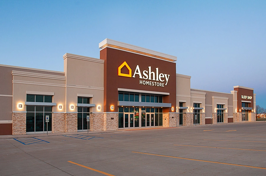 The Ashley Homestore Burlington location entrance is seen from across an empty parking lot.